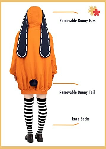 Person wearing an orange jacket with removable bunny ears and striped knee socks.