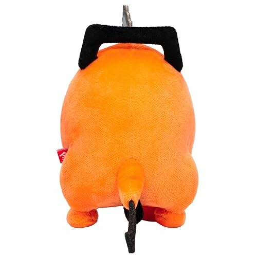 Rear view of an orange plush toy with black handle on top.