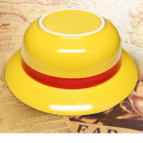 Yellow hat with red band on a vintage map background.